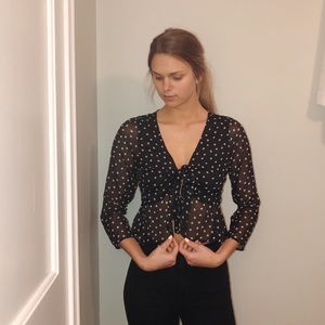 Sheer black and white polka dot cropped blouse.